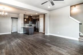 Bend apartment for rent - A spacious living room with a kitchen in the background.