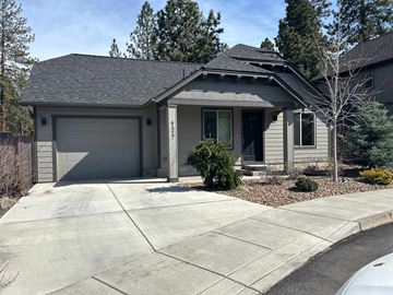 Bend house for rent - A house with a grey roof and a grey garage door.