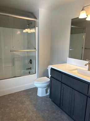 Bend house for rent - A bathroom with a toilet, sink, and shower.