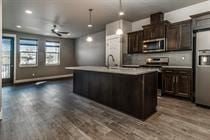 Bend apartment for rent - A modern kitchen with dark wood floors and stainless steel appliances.