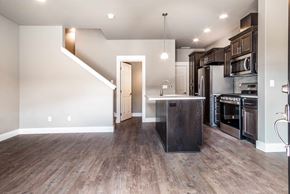 Bend apartment for rent - A kitchen with a wooden floor and a staircase.