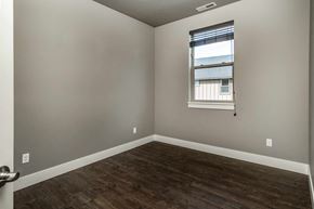 Bend apartment for rent - A room with a window and wooden flooring.