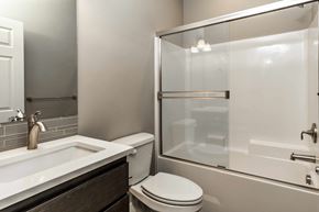 Bend apartment for rent - A white toilet sits next to a sink in a modern bathroom.