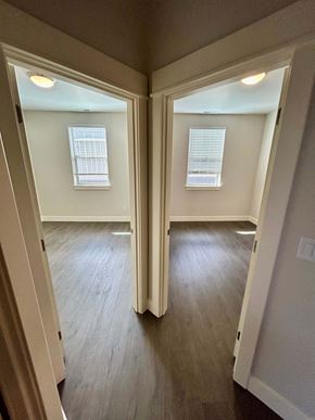 Bend apartment for rent - A room with two windows and wooden floors.