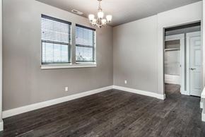 Bend apartment for rent - A room with wooden flooring and a chandelier.