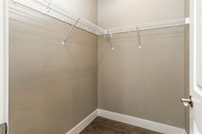 Bend apartment for rent - A white closet with a door and a shelf.