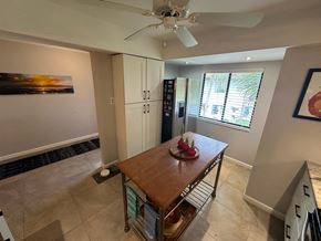 Bradenton house for rent - a kitchen with a table and a ceiling fan