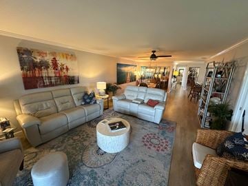 Bradenton house for rent - a living room and dining room with couches and a rug