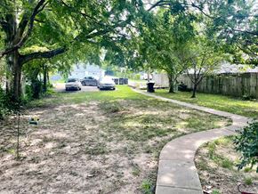Louisville apartment for rent - a sidewalk running through a yard with cars parked on the street