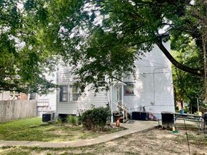 Louisville apartment for rent - a white house with a yard and trees