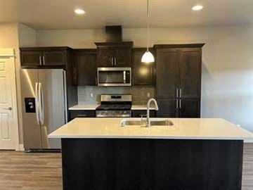 Bend apartment for rent - A kitchen with a white counter top and black cabinets.