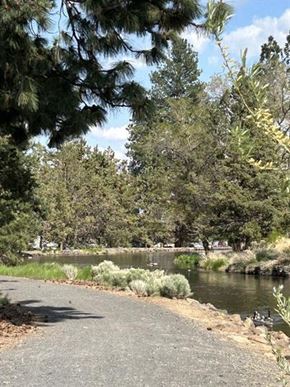Bend apartment for rent - A paved walkway runs alongside a body of water.