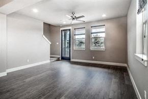 Bend apartment for rent - an empty living room with wood floors and a ceiling fan