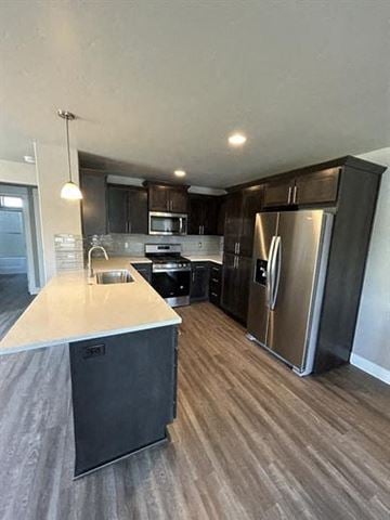 Bend apartment for rent - A modern kitchen with dark wood cabinets and stainless steel appliances.