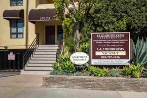 Van Nuys apartment for rent - A sign for Elizabeth Arms Apartments is displayed in front of a building.