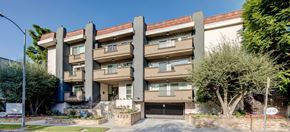 Sherman Oaks apartment for rent - a large apartment building with a driveway and trees