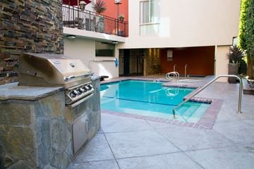 Studio City apartment for rent - A pool with a hot tub and a patio area.