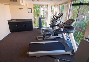 Studio City apartment for rent - A home gym with treadmills and elliptical machines.