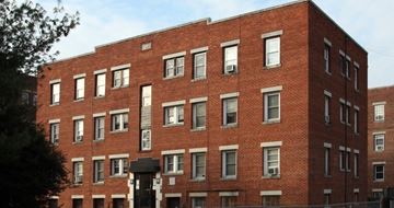 Washington apartment for rent - A red brick building with many windows.