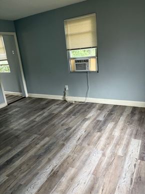 Washington apartment for rent - A room with wooden flooring and a window with blinds.