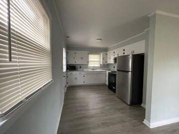 Lillington apartment for rent - a kitchen with white cabinets and a stainless steel refrigerator