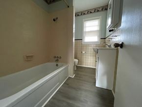 Lillington apartment for rent - a bathroom with a tub and a sink and a refrigerator
