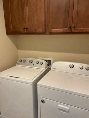 Denver house for rent - a kitchen with two white appliances and wooden cabinets