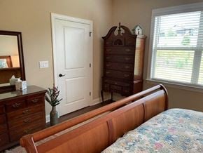 Denver house for rent - a bedroom with a bed and a dresser and a door