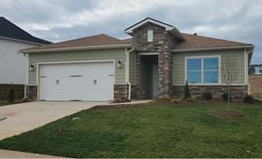 Denver house for rent - a house with a white garage door and a lawn