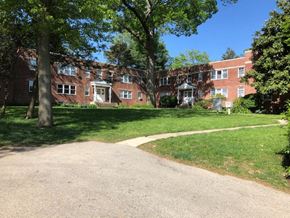 Bryn Mawr apartment for rent - A red brick building with a tree in front of it.