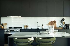 Ottawa apartment for rent - a kitchen with a marble counter top and black cabinets