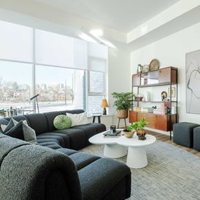 Ottawa apartment for rent - a living room with a large window and couches and a coffee table