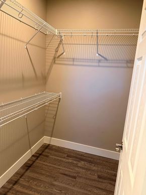 Bend apartment for rent - A walk in closet with shelves and a brown carpet.