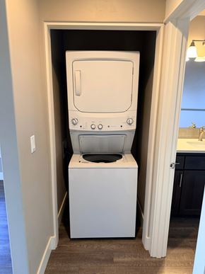 Bend apartment for rent - A white washing machine is in a small laundry room.