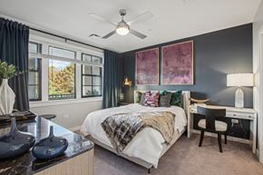 Hauppauge apartment for rent - a bedroom with a bed and a ceiling fan