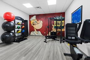 Neenah apartment for rent - A gym with a large painting of Santa Claus on the wall.
