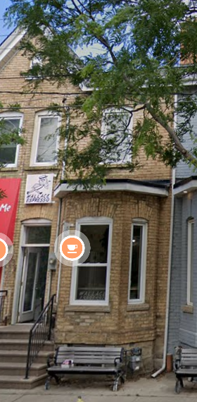 Toronto apartment for rent - A brown building with a red sign on the left side.