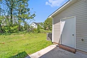 Jacksonville house for rent - A shed with a door open is in the foreground of a grassy area.