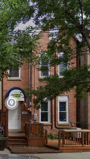 Toronto apartment for rent - A red brick building with a blue sign on it.