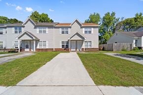 Jacksonville house for rent - A grey two-story house with a white front door and windows.