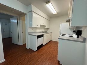 Austin apartment for rent - a kitchen with white cabinets and a stove and a refrigerator