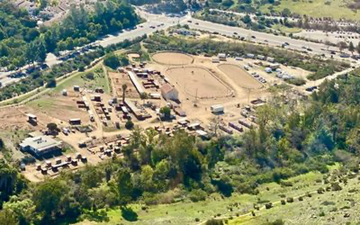 San Diego apartment for rent - An aerial view of a farm with a large open field and several buildings.