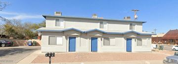 Tucson apartment for rent - a white house with blue doors on a street