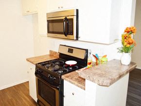 Canoga Park apartment for rent - a kitchen with a stove and a microwave