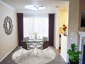 Canoga Park apartment for rent - a dining room with a table and chairs and a large window