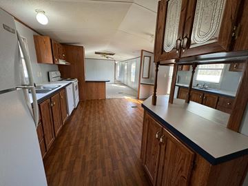 Mount Airy apartment for rent - A kitchen with wooden cabinets and a white fridge.