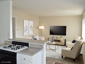 Upland apartment for rent - the view of the living room from the kitchen with the counter top and a stove