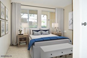 Glendora apartment for rent - a bedroom with a bed and three windows