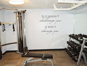 Sherman Oaks apartment for rent - a gym with weights and a white wall with the quote if it doesnt challenge