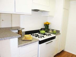 Sherman Oaks apartment for rent - a white kitchen with a stove and a counter top